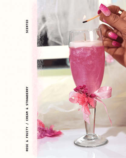 Pink candle in a champagne glass with floral decorations. Perfect for Wedding/ Bachalorette return favour.